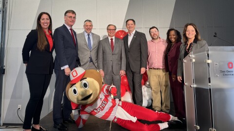 From left, Meredith Reffey, the department lead of workforce partnerships for American Honda Motor Co., Inc. and co-director of the Honda-Ohio State Paternship; John Horack, Senior Associate Dean of Engineering at Ohio State; Brett Roubinek with the Transportation Research Center; Bob Nelson, American Honda executive vice president; Larry Geise, executive vice president of Honda Development & Manufacturing; Seth Weinberg, Associate Dean for Research at OSU's College of Engineering; Ayanna Howard, dean of OSU's College of Engineering; Alissa Comella, associate vice president for corporate business development and Co-Director of the Honda-Ohio State Partnership, and Brutus Buckeye gather Thursday at 99P, Hondas innovation labs on Kinnear Road, to mark 25 years of formal partnership between Honda and Ohio State University.