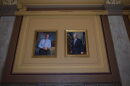 Portraits of former Govs. Mitch Daniels, left, and Joe Kernan hang side by side at the Indiana Statehouse as part of a new display intended to make the paintings more accessible to visitors.