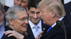 President Donald Trump congratulates Senate Majority Leader Mitch McConnell of Ky., while House Speaker Paul Ryan of Wis., watches to acknowledge the final passage of tax overhaul legislation by Congress at the White House in Washington, Wednesday, Dec. 20, 2017. (AP Photo/Manuel Balce Ceneta)