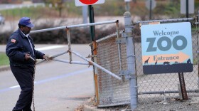 A security guard closes the gate at the Pittsburgh Zoo, where a 2-year-old boy was killed Sunday.