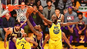 LeBron James of the Los Angeles Lakers (C) goes to the hoop under pressure from Draymond Green (R) of the Golden State Warriors during their the regular season game at the Staples Center in Los Angeles on November 13, 2019. (FREDERIC J. BROWN/AFP via Getty Images)