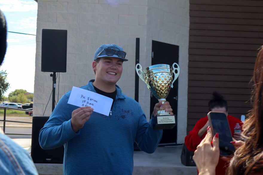 Ryder Boykin shows off award from the pie eating contest. Photo by Emma Coats
