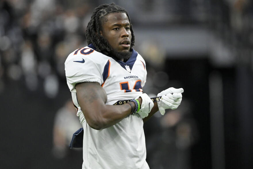 FILE - Denver Broncos wide receiver Jerry Jeudy (10) adjusts his equipment before an NFL football game against the Las Vegas Raiders, Sunday, Dec. 26, 2021, in Las Vegas. At the request of prosecutors, a suburban Denver judge on Tuesday, May 31, 2022, dismissed charges against Broncos wide receiver Jerry Jeudy stemming from a dispute with his girlfriend that landed him in jail. Arapahoe County District Court Judge Chantel Contiguglia closed the case after the county district attorney's office filed a motion to dismiss the charges, said Eric Ross, a spokesman for the 18th Judicial District Attorney's Office. (AP Photo/David Becker, File)