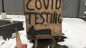 A spray painted wooded sign for COVID testing. 