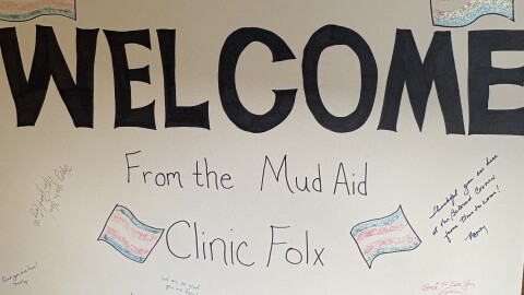 A sign with encouraging messages from members of Beloved Community Church welcomes clinic attendees.