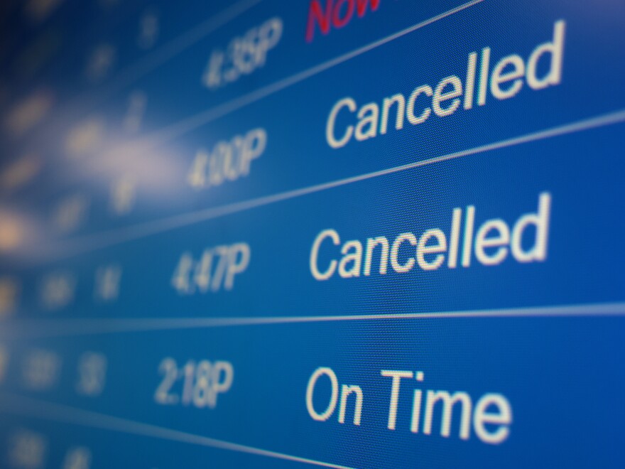 A flight information display system shows cancelled flights at the Ronald Reagan Washington National Airport on Dec. 27, 2021, in Arlington, Va. Flight cancellations became a regular occurrence in December as the omicron variant infected staff at airports and airlines.