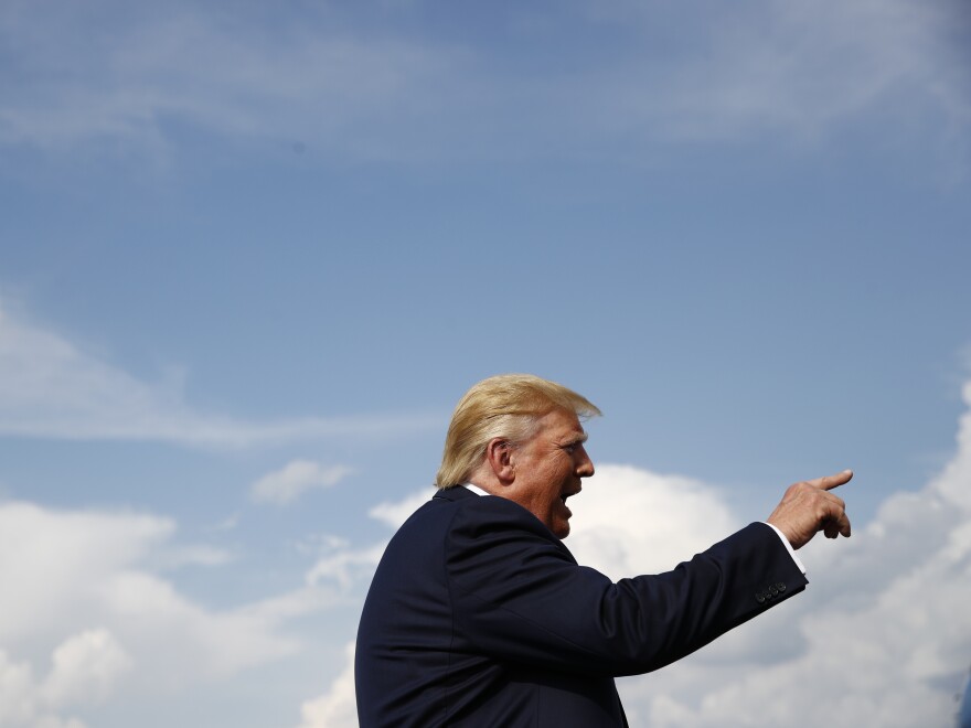 President Trump speaks with reporters before boarding Air Force One at Morristown Municipal Airport in Morristown, N.J., on Sunday. Among the topics was Trump's interest in buying Greenland from Denmark.