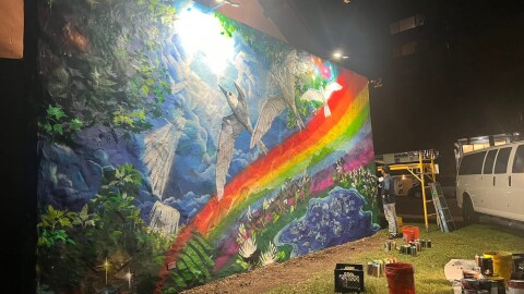 Todd "Estria" Johnson, far right, putting the final touches on the latest mural at the Lutheran Church of Honolulu. (May 2026)