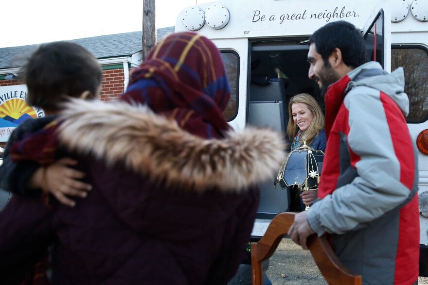 Kari Miller, the founder of International Neighbors, helps the Zaki family, who resettled from Afghanistan, load up the donated items they received from the Earlysville Exchange. The exchange is a thrift store just north of Charlottesville.