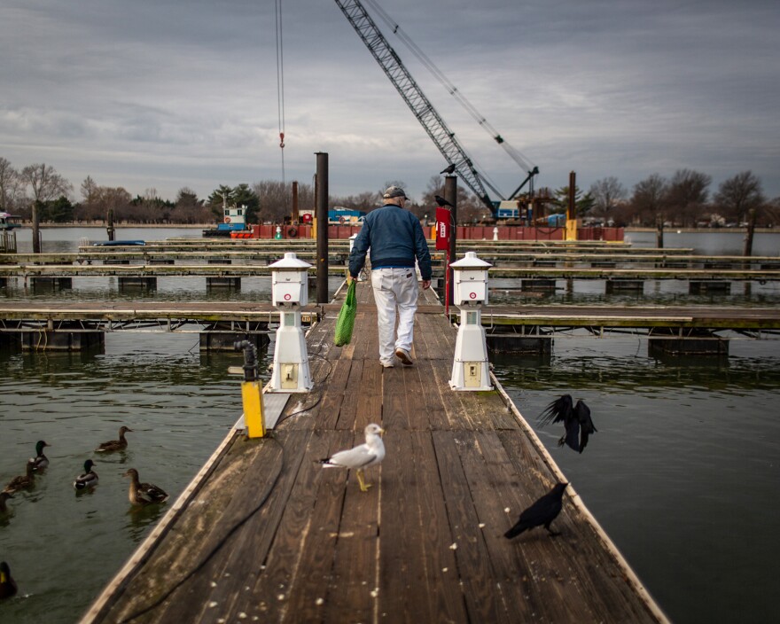 Thiel feeds the birds on the last day that Gangplank residents had access to the marina's wooden docks.