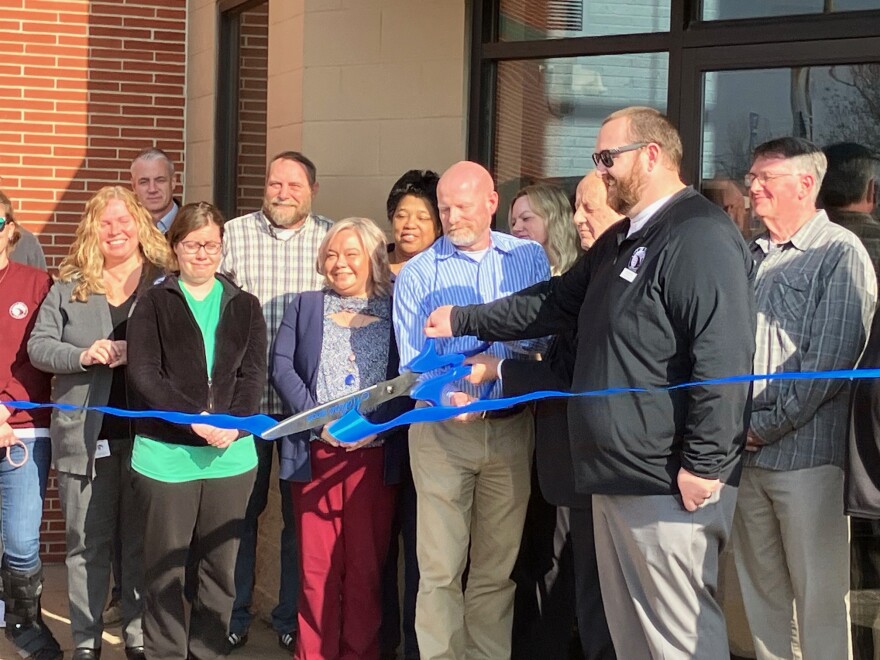Moline parks and recreation director Eric Griffith (in sunglasses) helps community and economic development director Chris Mathias and city administrator Bob Vitas cut the ribbon the new Moline City Services Center, Thursday, March 5, 2026.