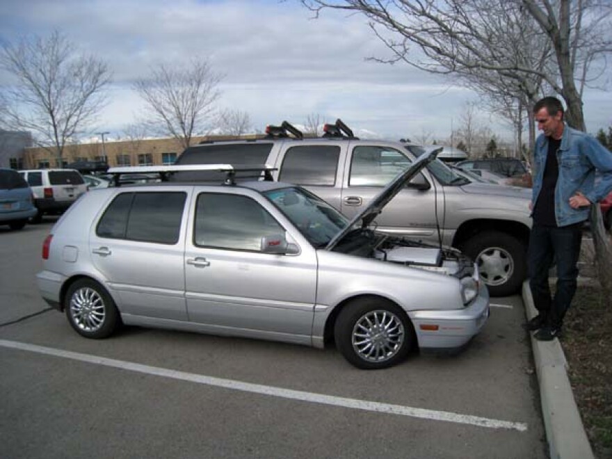 Kyle Dansie of ZEV Utah stands next to his solar/electric-powered 1993 VW Golf.