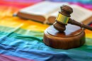 A judge's gavel, legal terms and forms related to LGBTQ rights and liability 