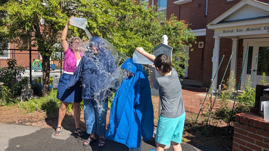 St. Paul's Senior Pastor Carolyn Williamson and Associate Pastor MaryAnn Piccioni said they'd endure a soaking from congregants if at least 100 buckets were filled. The 130-bucket total compelled them to fulfill that promise.