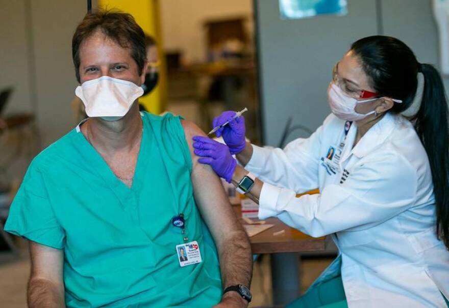 Dr. Aharon Sareli receives the first dose of the Pfizer BioNTech Vaccine at Memorial Specialty Pharmacy in Miramar, Florida on Monday, December 14, 2020.