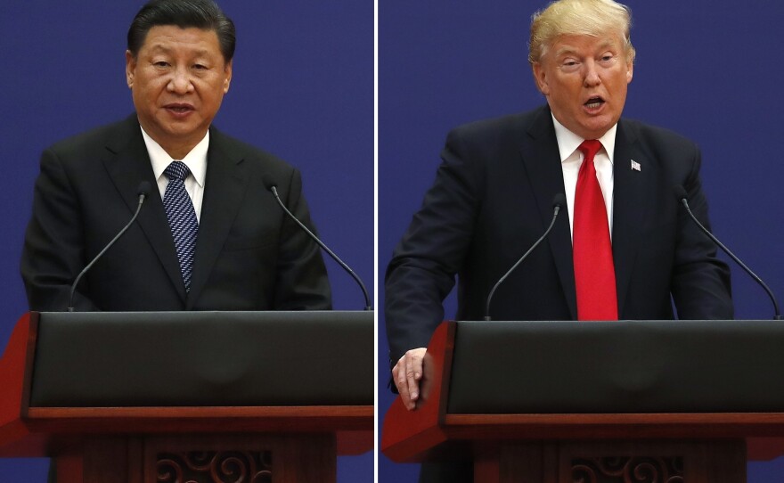 U.S. President Donald Trump, right, and Chinese President Xi Jinping speak during a business event at the Great Hall of the People in Beijing November 2017.