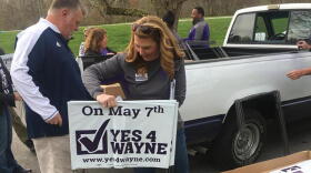 Volunteers distribute signs for Wayne Township Schools ahead of the May 2019 election.