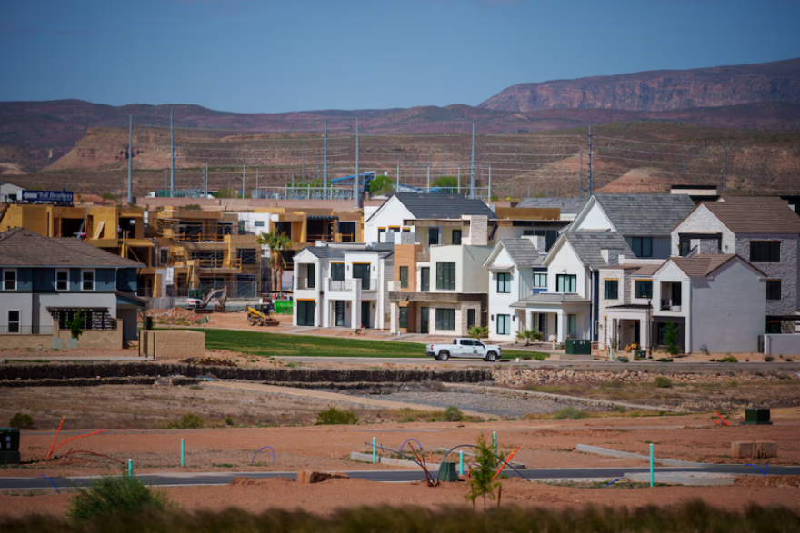 Construction surrounding houses with mountains in the background