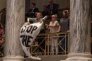 Jaeda Roth and other protestors from Abortion Access Missouri unfurl banners as the Missouri Senate passes a proposed constitutional amendment to ban abortion in May 2025.