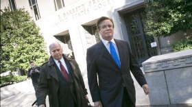 Former Trump campaign chairman Paul Manafort (right) leaves federal court after pleading not guilty following his indictment on federal charges Monday.