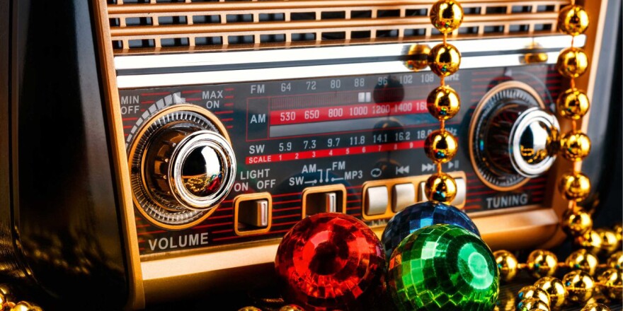 Vintage radio draped with holiday ornaments