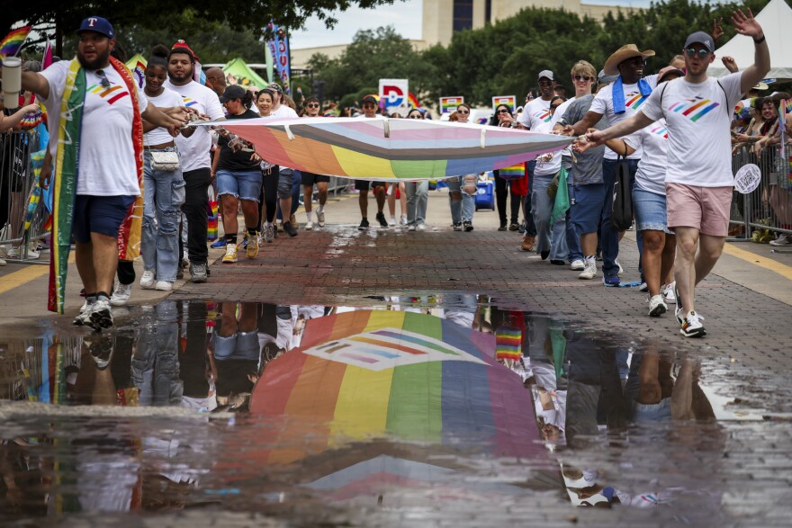 Bank of America employees carry a Pride flag as they march in the Dallas Pride parade on June 15, 2025.