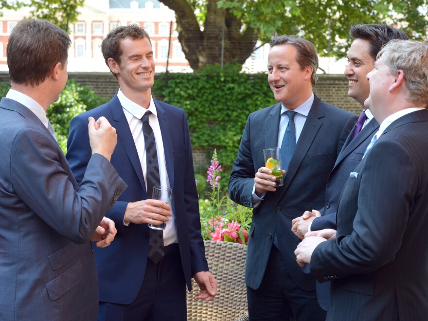 Something to cheer about: Scotland's Andy Murray (second from left) speaks with Britain's Deputy Prime Minister Nick Clegg and Prime Minister David Cameron (center) after winning the men's title at Wimbledon.