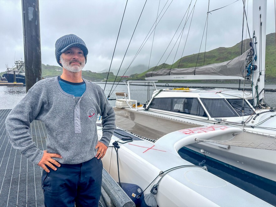 Luke Moloney stands in front of his sailboat, the Mizuya, docked in Unalaska on July 18.