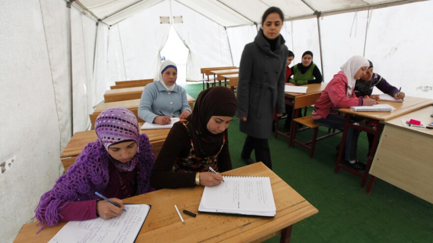 Syrian girls attend a class in a makeshift classroom at a refugee camp on the Turkish-Syrian border in southern Turkey's Hatay province, on Feb. 8. More than 12,000 Syrians live in refugee camps in Hatay, and several thousand more have found accommodations elsewhere.