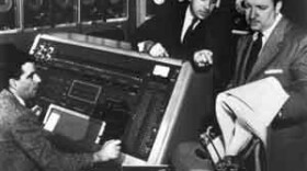 Two Remington Rand employees demonstrate the UNIVAC for Walter Cronkite in 1952