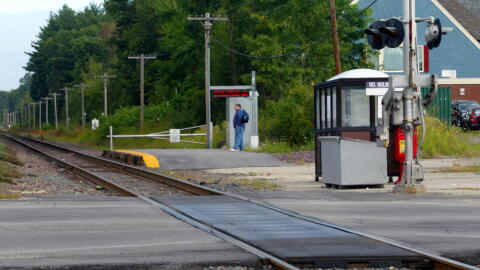 A commuter waits for the morning train at the North Wilmington stop on the Haverhill line. (Joanne Rathe/The Boston Globe via Getty Images)