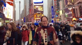 Barsky stands in New York City's Times Square wearing none other than his sweater of Times Square.