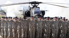 FILE - In this Friday, May 13, 2011 file photo, Soldiers of 1AD attend a color casing ceremony of the First Armored Division at the US Army Airfield in Wiesbaden, Germany. After more than a year of thinly veiled threats that the United States could start pulling troops out of Germany unless the country increases its defense spending to NATO standards, President Donald Trump appears to be going ahead with the hardball approach with a plan to reduce the American military presence in the country by more than 25 percent. (AP Photo/Michael Probst, file)