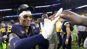 Michigan defensive back Will Johnson celebrates after their win against Washington in the national championship NCAA College Football Playoff game Monday, Jan. 8, 2024, in Houston. Johnson wears a pair of Cartier Buffs. (AP Photo/David J. Phillip)