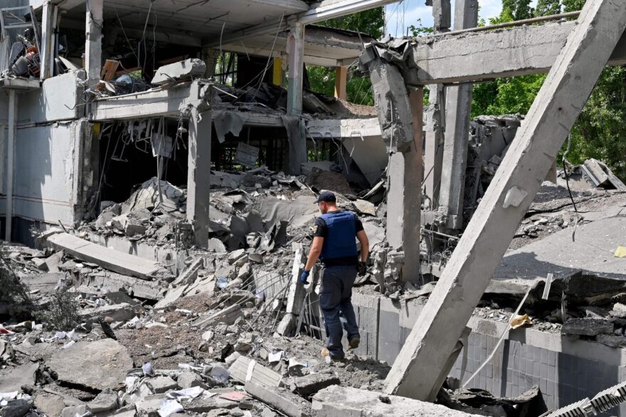 A rescuer walks among ruins of a school in Kharkiv, partially destroyed by a rocket as Russian forces are solidifying their hold on the eastern Donbas region and pushing steadily towards Ukraine's de facto administrative centre in that region, Kramatorsk.