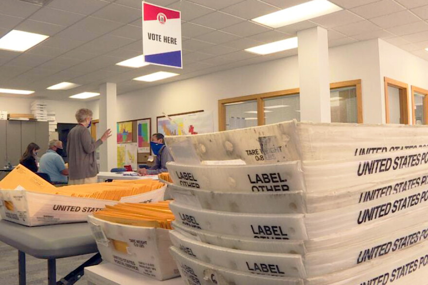 Election workers in Monroe County prepare mail-in ballots. The county has received a record number already and is expecting more.