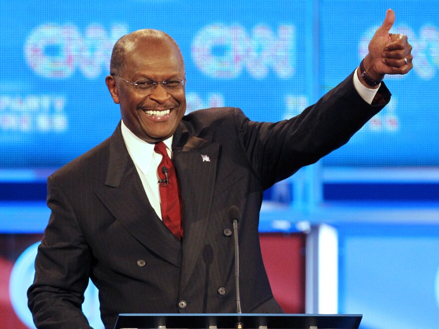 Republican presidential candidate businessman Herman Cain gives the thumbs up during a break in a Republican presidential debate Monday, Sept. 12, 2011, in Tampa, Fla. (AP Photo/Mike Carlson)