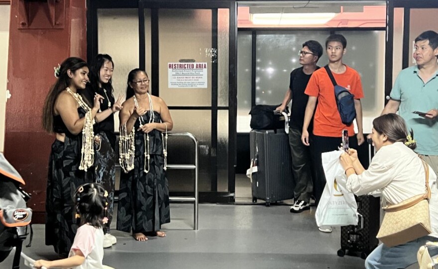 Passengers arriving aboard Hong Kong Airlines' first nonstop flight from Hong Kong to Saipan on July 13, 2026, receive a traditional island welcome from cultural performers at Francisco C. Ada/Saipan International Airport. Additional airlines restarting flights to Saipan include United Airlines from Tokyo Narita on Aug. 2, and Philippine Airlines from Manila in October.