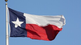 The Texas flag flies in Austin.
