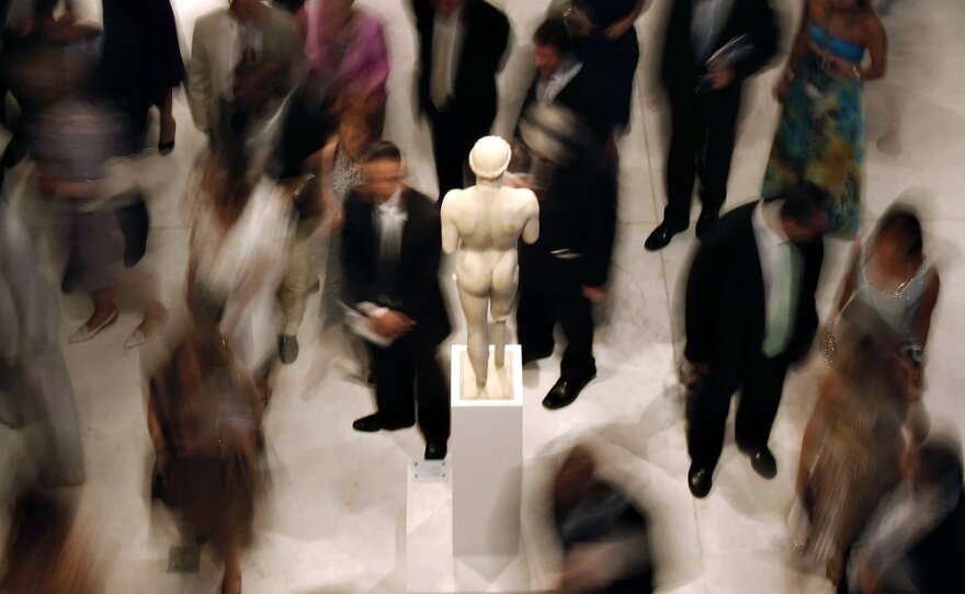 Officials and dignitaries tour the museum at its official opening in June. Greek officials say the museum should also display multiple sculptures that were first removed from the Parthenon frieze 200 years ago by Lord Elgin and later sold to the British Museum. 