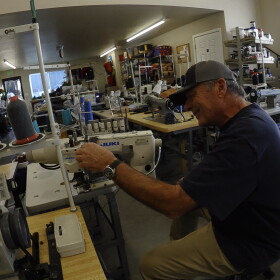 Erik Dalton loos on as as Kurt Gray explains a sewing machine