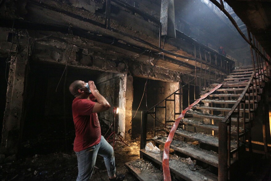 An Iraqi man looks for victims at the bomb site in Baghdad.