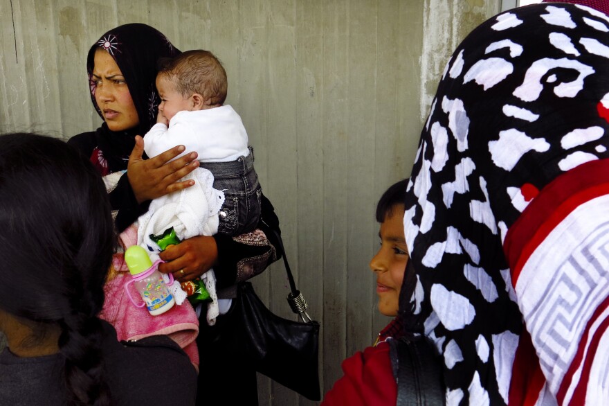 Um Ahmed and her infant daughter wait to register at a U.N. center in the town of Al Mina, in northern Lebanon near the border with Syria.