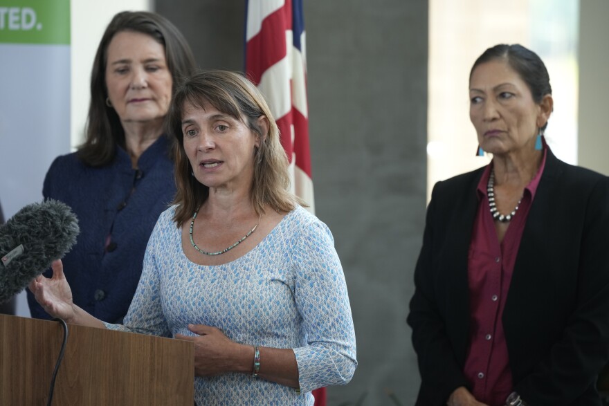 FILE - Tanya Trujillo, assistant secretary for water and science at the Department of the Interior, front, makes a point as U.S. Rep Diana DeGette, D-Colo., back left, and Interior Secretary Deb Haaland look on during a news conference at the offices of Denver Water, July 22, 2021, in Denver. Trujillo, a key official overseeing Colorado River negotiations, will step down from her role with the Interior Department on Monday, July 17, 2023.