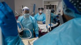 Medical staff prepare for an intubation procedure on a COVID-19 patient in a Houston intensive care unit. In some parts of the U.S., as hospitals get crowded, hospital leaders are worried they may need to implement crisis standards of care.