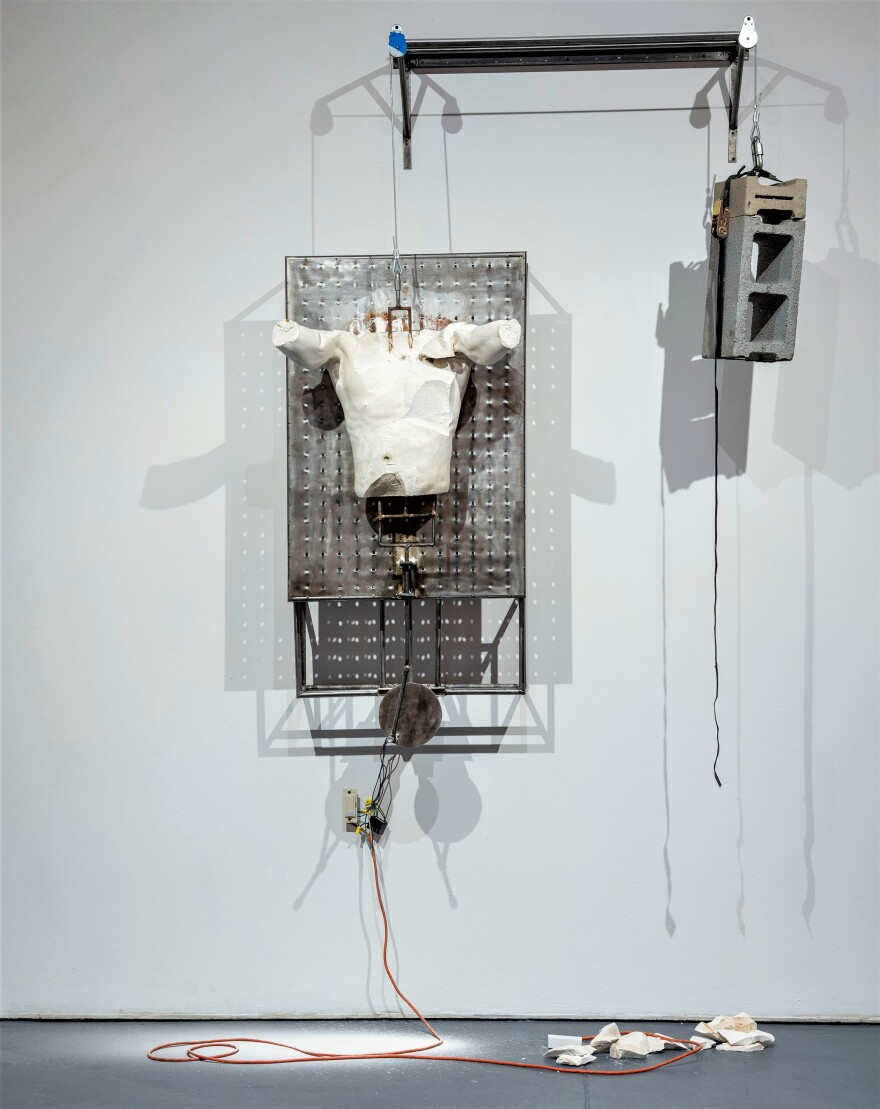 Jeffrey Meris, "The Block is Hot: The Resurrection," plaster body cast, AC motor, steel, concrete-blocks, aircraft cable, U link, pulleys, ratchet strap, 2023