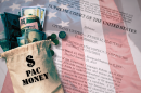 A brown sack of money sits on top of an American flag and a transparent copy of the Supreme Court decision on Citizens United vs. FEC. 