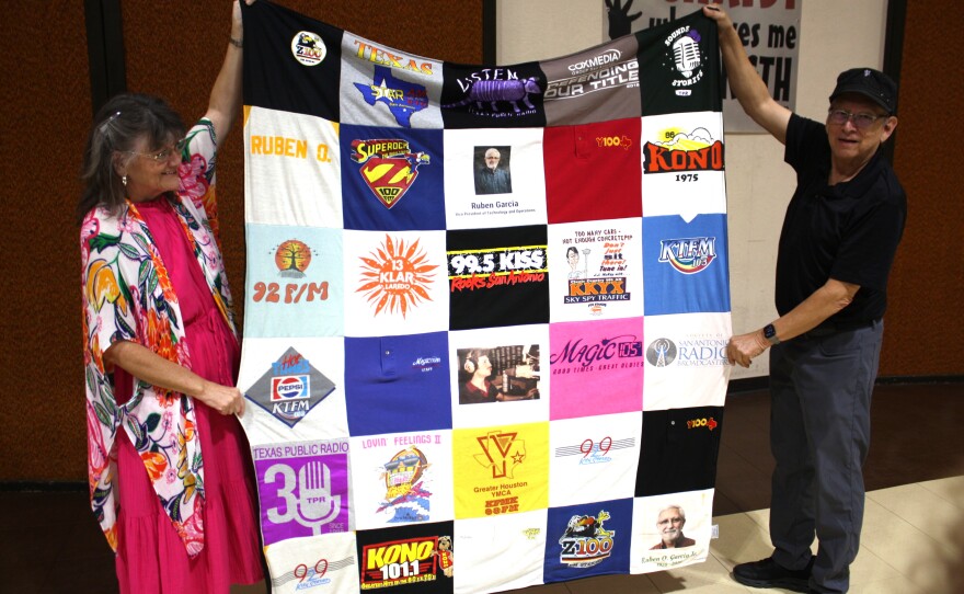 A quilt made from Ruben Garcia's radio T-shirts is displayed.