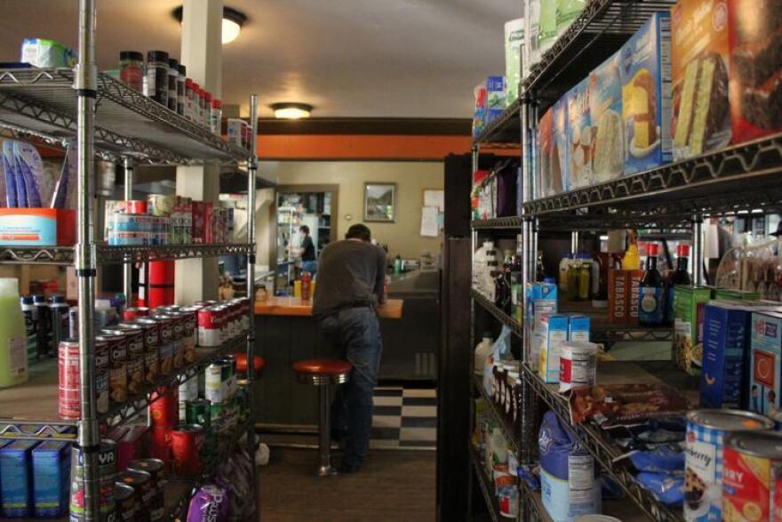 A regular stands at the counter at the South Aworth Village Store on a recent afternoon. It's a popular spot in town for breakfast, staples and company.
