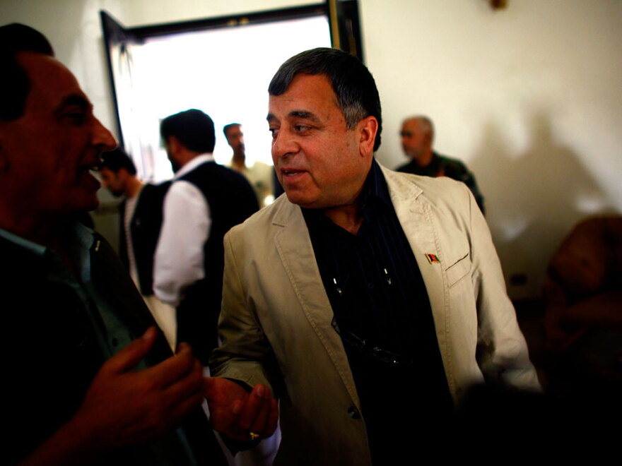 One of the main challenges facing Kandahar's governor, Tooryalai Wesa, is a shortage of staff for local governments. Some districts in the province have only one or two officials. Here, Wesa talks with local officials at the end of a conference in Kandahar, on Monday.